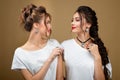 Fashion Portrait Of two beautiful luxury women with jewelry. Photo of young women wearing shiny necklace and earrings