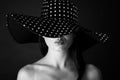 Fashion portrait of a woman with black and white dots hat and pout lips Royalty Free Stock Photo