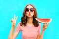 Fashion portrait woman is holding a slice of watermelon and blowing lips Royalty Free Stock Photo