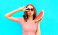 Fashion portrait woman is holding slice of watermelon and blowing lips Royalty Free Stock Photo