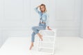 Fashion portrait of woman in ripped jeans