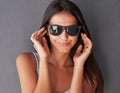 Fashion, portrait or woman in sunglasses in studio on grey background for cool eyewear and modern style. Model, trendy Royalty Free Stock Photo