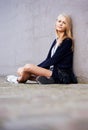 Fashion, portrait and woman by wall in city, relax and outdoor alone. Beauty, style and young person in urban town Royalty Free Stock Photo
