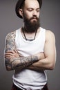 Hipster boy with tattoo. handsome man in hat Royalty Free Stock Photo