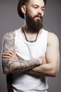 Hipster boy with tattoo. handsome man in hat Royalty Free Stock Photo