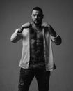 Fashion portrait of young bearded man. Looking at camera isolated on gray. Handsome macho. Brutal bearded coach with