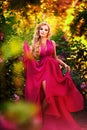 Fashion portrait of young beautiful girl posing against lilac bushes in blossom Royalty Free Stock Photo