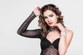 Fashion portrait of young beautiful sexy woman in jewelry.Beauty girl with long curly hair and make-up. Elegant lady in black Royalty Free Stock Photo