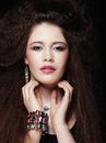 Fashion portrait of young beautiful woman with jewelry and elegant hairstyle.Perfect make-up. Beauty style model. Royalty Free Stock Photo