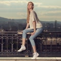 Fashion portrait of blonde woman. Jeans and sneakers. Royalty Free Stock Photo
