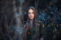 Fashion portrait of young boho girl at sunset posing on nature