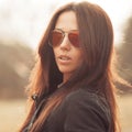 Fashion portrait of young brunette woman in sunglasses - close u
