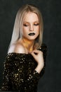 Fashion portrait of young caucasian model with golden sparkles on her neck.