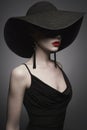 Portrait of young lady with black hat and evening dress Royalty Free Stock Photo