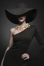 Portrait of young lady with black hat and evening dress Royalty Free Stock Photo