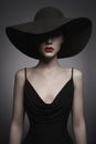 Portrait of young lady with black hat and evening dress Royalty Free Stock Photo