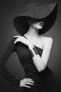 Portrait of young lady with black hat and evening dress Royalty Free Stock Photo