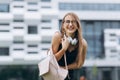 Fashion portrait of young stylish hipster woman walking on the street, wearing cute trendy outfit, smiling enjoy her Royalty Free Stock Photo