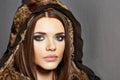 Fashion portraitof young woman with fur clothes.