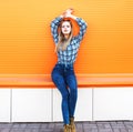 Fashion pretty blonde girl model over colorful orange Royalty Free Stock Photo