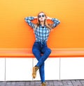 Fashion pretty blonde girl posing over orange background Royalty Free Stock Photo