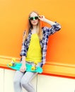 Fashion pretty blonde girl wearing a sunglasses with skateboard Royalty Free Stock Photo