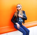 Fashion pretty blonde slim woman over a colorful orange background Royalty Free Stock Photo