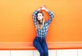 Fashion pretty blonde woman in city over colorful orange Royalty Free Stock Photo