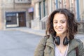 Fashion pretty cool girl wearing headphones having fun over urban background Royalty Free Stock Photo