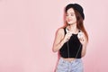 Fashion pretty cool woman in hat and headphones listening to music over pink background. Beautiful young teenage girl in hat Royalty Free Stock Photo