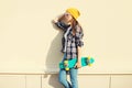 Fashion pretty girl wearing a colorful clothes with skateboard Royalty Free Stock Photo