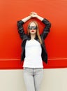 Fashion pretty stylish woman wearing a rock black jacket and sunglasses in city Royalty Free Stock Photo