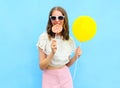 Fashion pretty woman with air balloon and lollipop over colorful blue Royalty Free Stock Photo