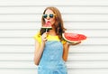 Fashion pretty woman eating a slice of watermelon in the form of ice cream Royalty Free Stock Photo