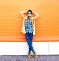 Fashion pretty woman model posing over orange background Royalty Free Stock Photo