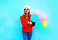 Fashion pretty woman sends an air kiss holds a balloons Royalty Free Stock Photo