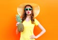 Fashion pretty woman in a sunglasses with pineapple over colorful Royalty Free Stock Photo