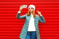 Fashion pretty woman takes a picture self portrait on a smartphone Royalty Free Stock Photo