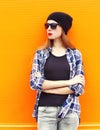 Fashion pretty woman wearing a black hat, sunglasses and shirt over colorful background Royalty Free Stock Photo