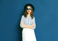 Fashion pretty woman wearing a black sunglasses, hat and white skirt Royalty Free Stock Photo