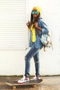 Fashion pretty young african woman riding on skateboard Royalty Free Stock Photo