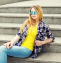 Fashion pretty young girl wearing a checkered shirt and sunglasses Royalty Free Stock Photo