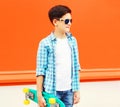 Fashion profile teenager boy with skateboard poses on colorful Royalty Free Stock Photo