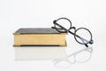 Fashion reading glasses on old book on white background Royalty Free Stock Photo