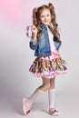 Fashion redhead girl in a festive outfit posing and smiling. Studio photo on light coloured background. Birthday, holiday Royalty Free Stock Photo