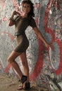 Fashion runway model posing at locations with graffiti on the walls Royalty Free Stock Photo