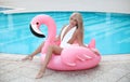 Fashion blond model woman in white bikini posing on Pink in Royalty Free Stock Photo