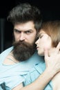 Fashion shot of couple after haircut. Barbershop concept. Man with stylish beard and mustache and girl with fresh