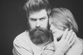Fashion shot of couple after haircut. Hairstyle concept. Woman on mysterious face with bearded man, black background Royalty Free Stock Photo