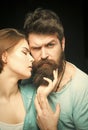 Fashion shot of couple after haircut. Woman on mysterious face with bearded man, black background. Barbershop concept Royalty Free Stock Photo